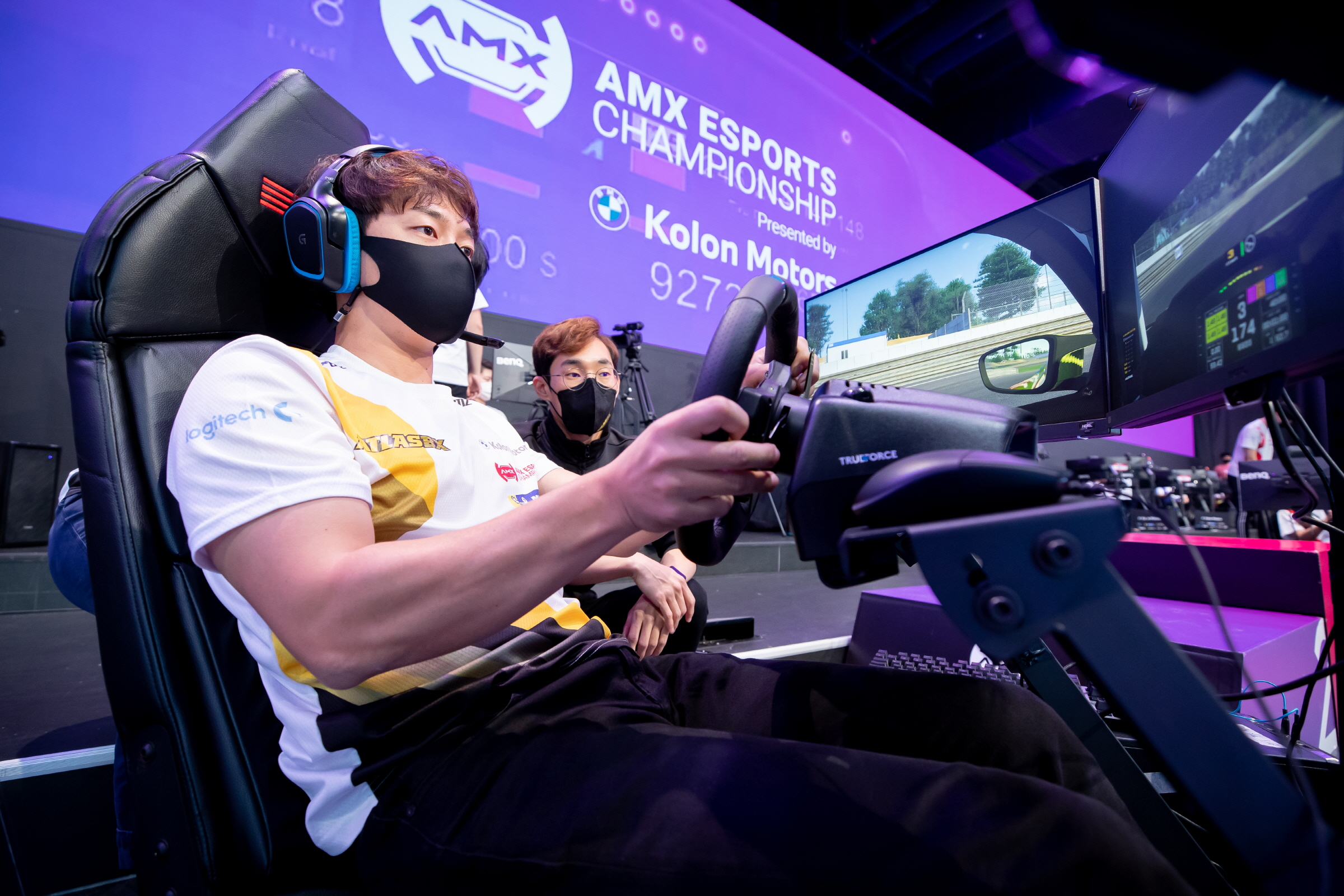 A participant at a sim racing setup at the 2021 AMX eSports Championship